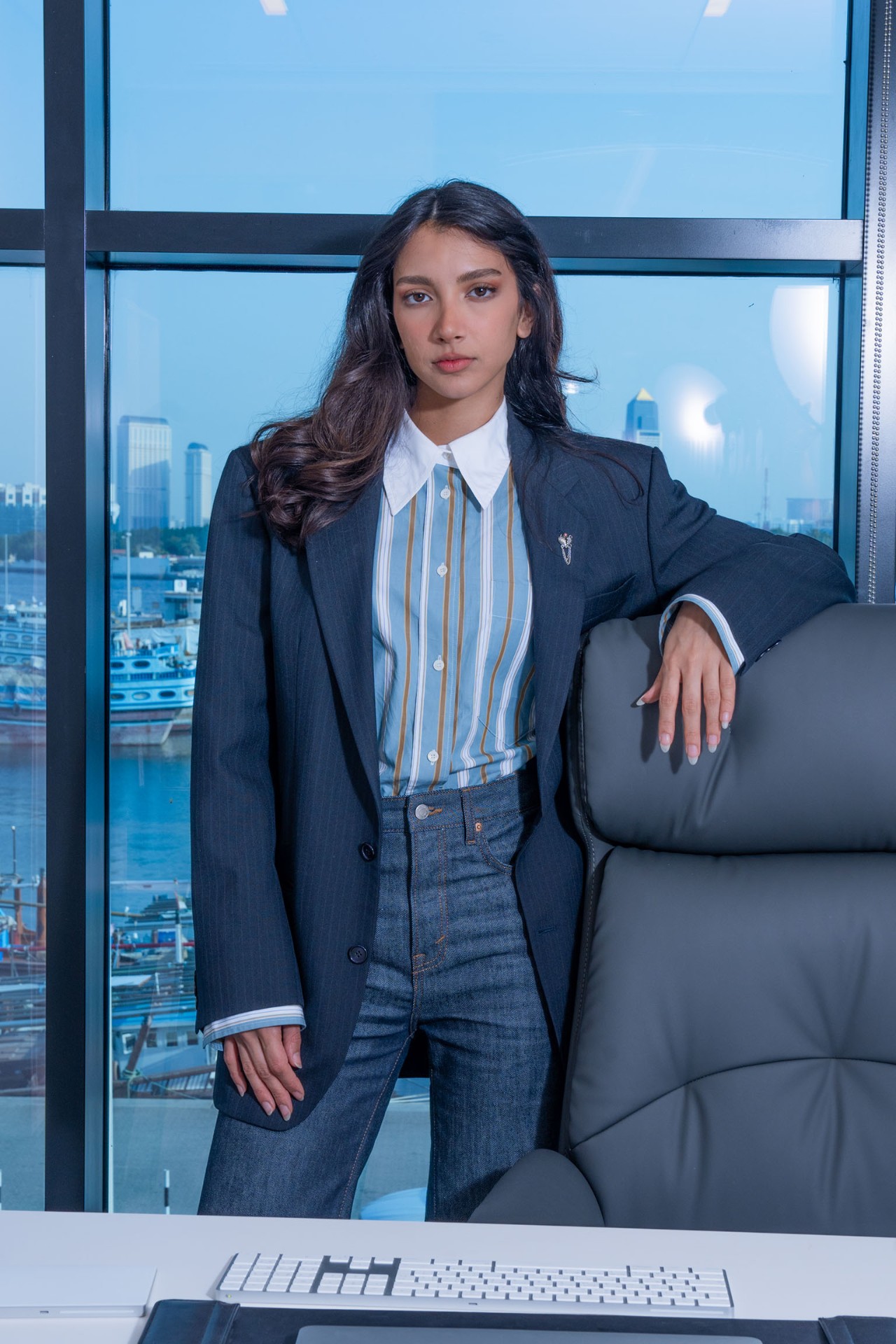 Corporate portrait by office window with skyline