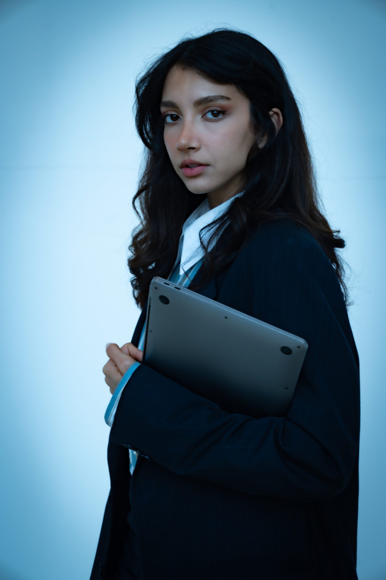 Moody blue-lit portrait with laptop