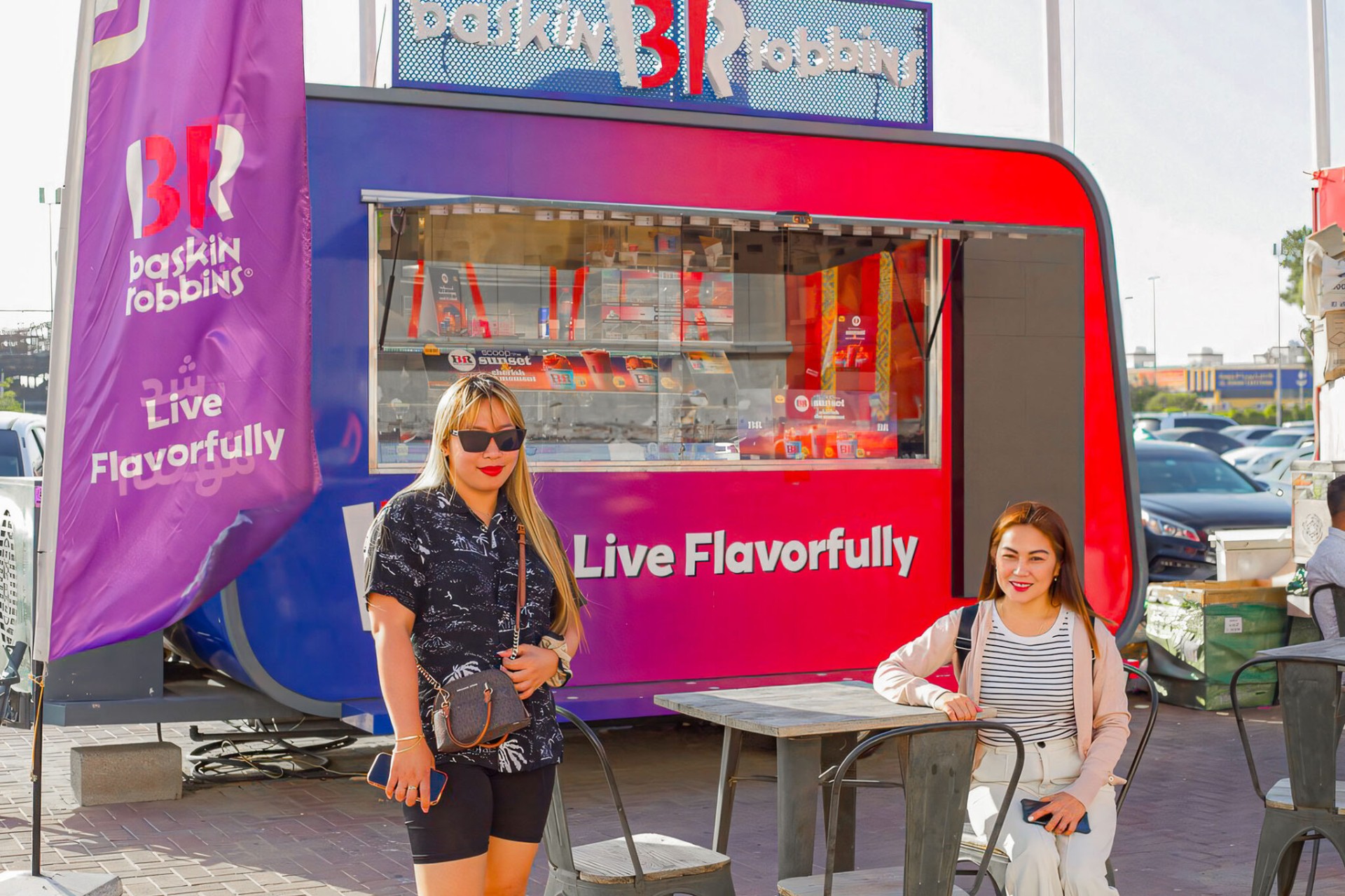 Two women at Baskin Robbins stand