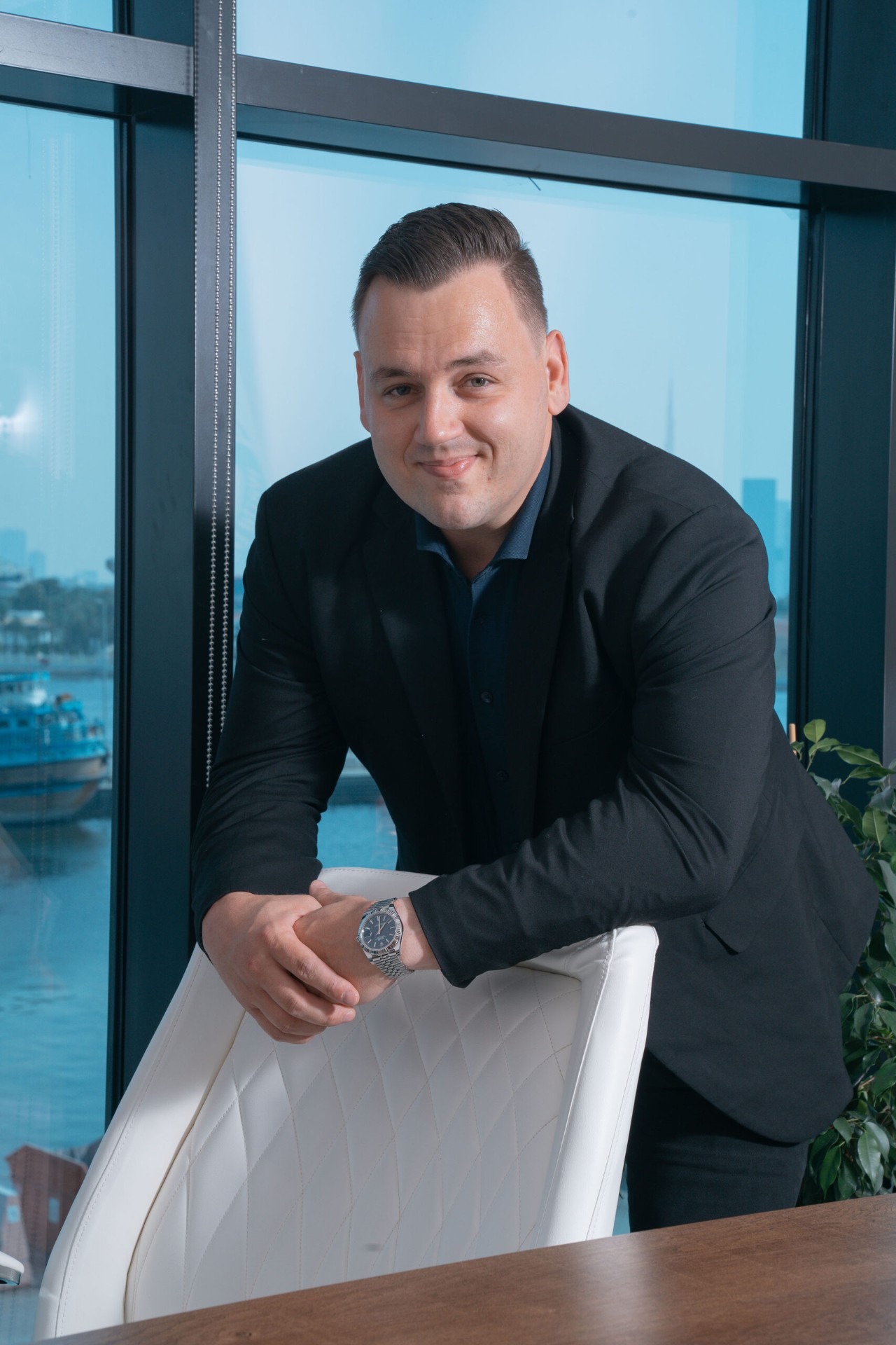 Standing executive portrait by office window