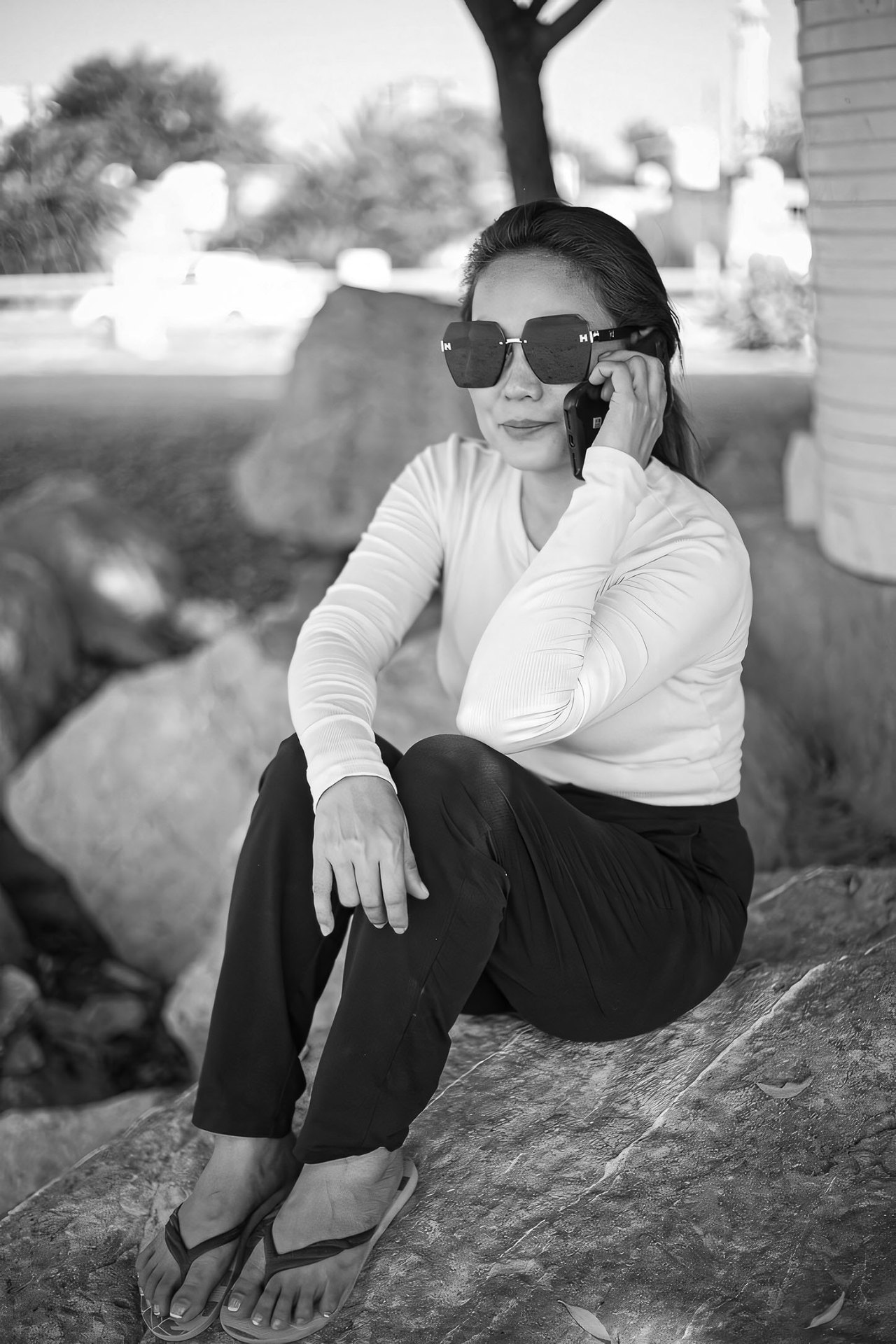 Black and white candid portrait on phone
