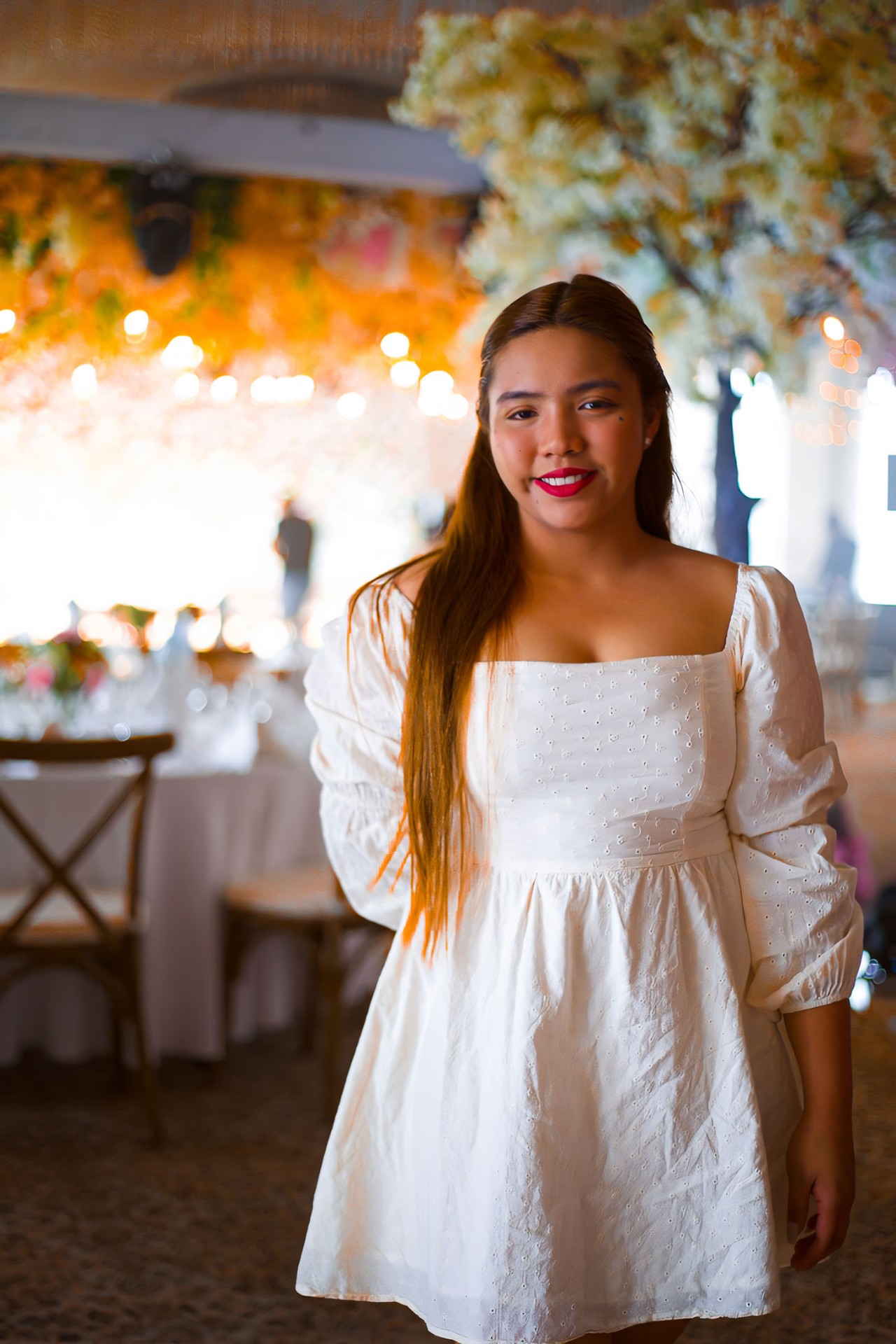 Portrait in white dress at floral venue